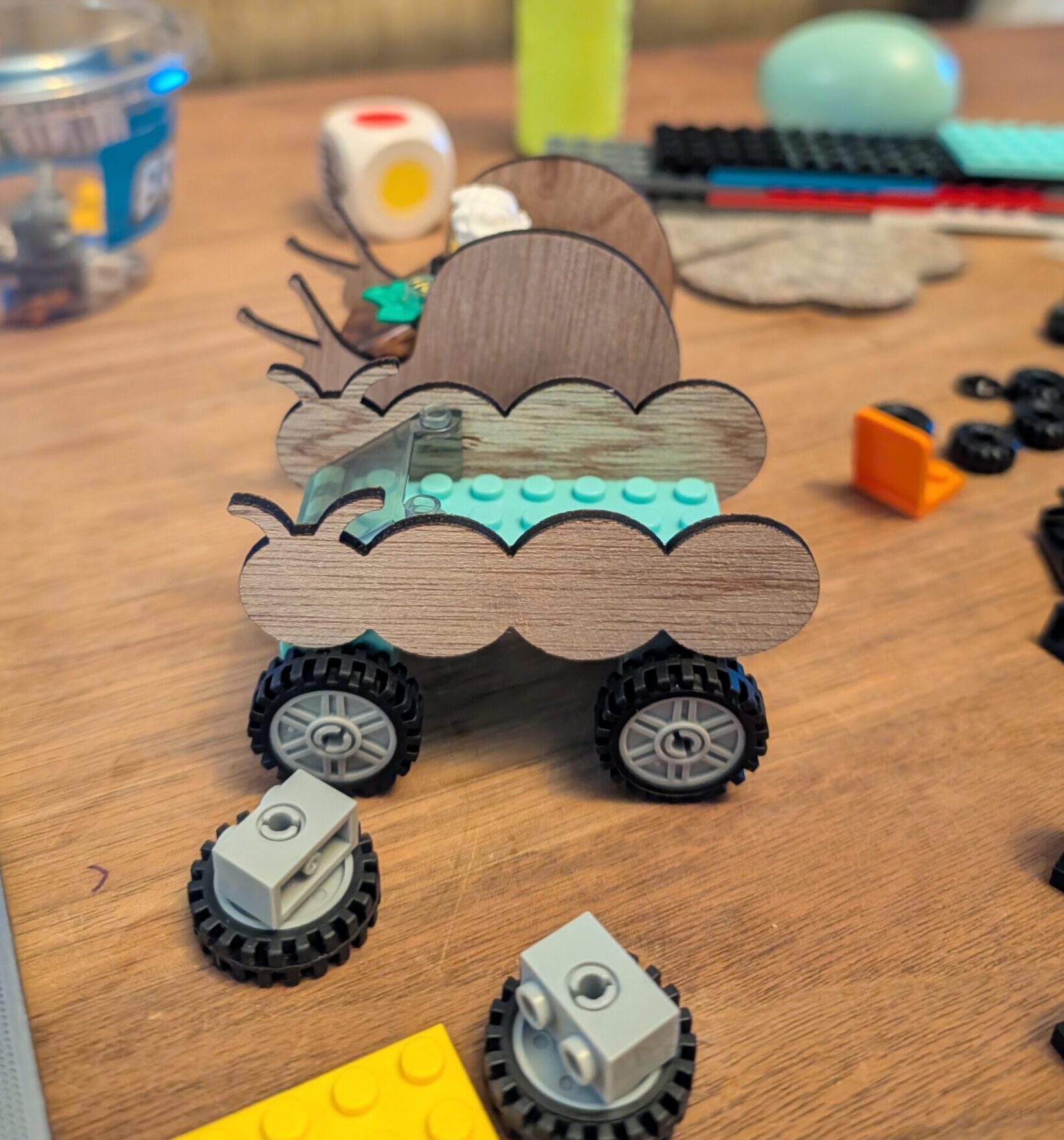 Caterpillar and Snail LEGO cars being built.